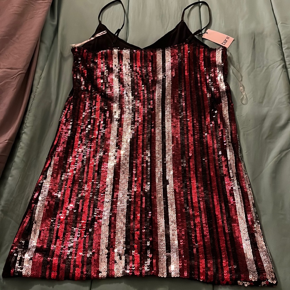 Never worn. Beautiful sequins dress Black, Red and Silver. Very flirty and sexy.